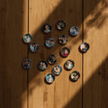 Circular photo prints of people arranged in a heart shape on a wooden surface.